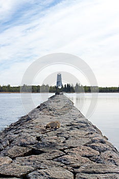 Stone pier to the lighthouse lake Ladoga