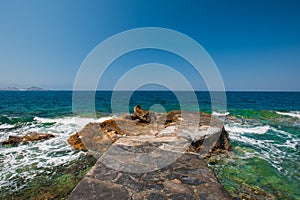 Stone pier wrecked pier. azure surface of water