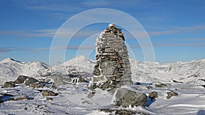 Stone pile in snow on Mount Hoven in Loen in Vestland in Norway