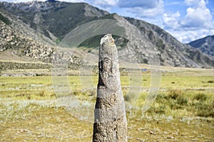 Stone pillar depicting a male face ancient Scythian period, Altai mountains, Russia
