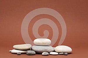 Stone podium, many pebbles on brown background