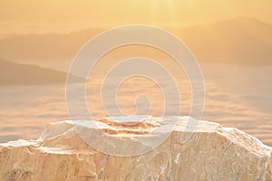 Stone podium table top with outdoor mountains golden color scene nature landscape at sunrise blur background.Natural beauty