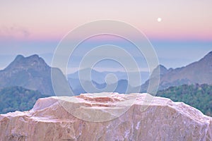 Stone podium table top with outdoor mountains pastel color scene nature landscape at sunrise blur background.Natural beauty