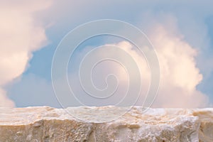 Stone podium tabletop floor in outdoor on sky pink gold pastel soft cloud blurred background.Beauty cosmetic product placement