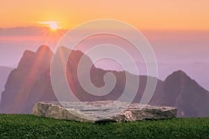 Stone podium tabletop floor outdoors on pink sky at sunset with beautiful mountain nature landscape background.Cosmetic product