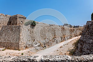 Stone powerful walls of old city, the ancient defense of Old Town, Rhodes, Dodecanese, Greece.