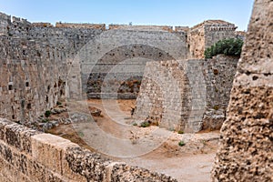 Stone powerful walls of old city, the ancient defense of Old Town, Rhodes, Dodecanese, Greece.