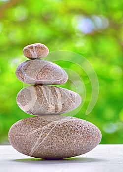 Stone pyramid over natural background photo