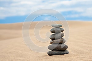 Stone pyramid on sand