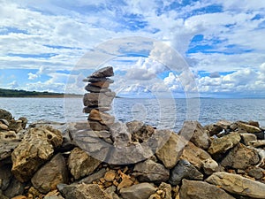 Stone Pyramid on The Seashore with Beautiful Cloudy Sky in the Background