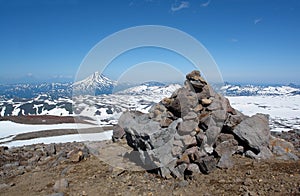 Stone pyramid on the slope of Gorely volcano. Vilyuchinsky volcano is visible on the background, Kamchatka Peninsula photo