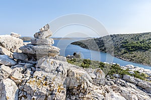 Stone pyramid on top of the mountain of the island of Lavsa of the Kornati archipelago in the Adriatic sea photo
