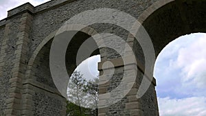 Stone railway arch bridge, high old viaduct. Transport construction, historical architecture