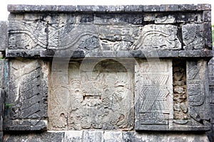 Stone relief carvings on the wall of the Plataforma de Venus, Chichen-Itza, Yucatan, Mexico photo