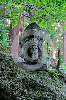 Stone religious statue stands on a hill