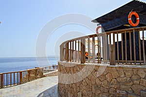 A stone rescue tower, a lifeguard post with a view of the sea from a height and a lifebuoy