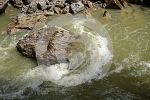 Stone in river with water steam flowing for background