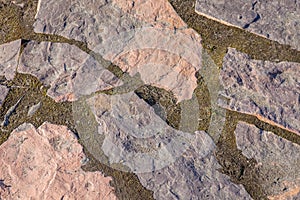 Stone road from granite to the lake close-up