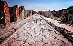 The stone road in the middle of ruins in the historical town Pompei