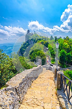 Stone road to Seconda Torre La Cesta Republic San Marino second fortress tower with brick walls on Mount Titano photo