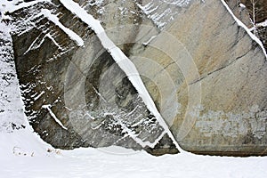Stone rock covered with snow