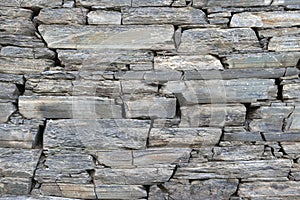 Stone rock texture wall background. Wall rough old piece rock of mountains. Natural stone masonry without mortar and cement, an ol