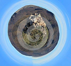 Stone rock towers over the landscape. Spherical panorama