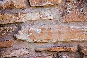 Stone rock wall rough mortar brown tan old stack background