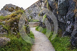 Stone rocks mountain hiking path at Irish seacoast