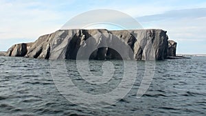 Stone rocks among water surface of Arctic Ocean on New Earth Vaigach Island.