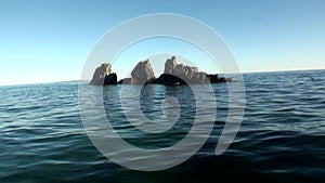 Stone rocks among the watery surface of Arctic Ocean on New Earth.