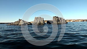 Stone rocks among the watery surface of Arctic Ocean on New Earth.