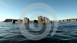 Stone rocks among the watery surface of Arctic Ocean on New Earth.