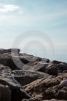 Stone rocky shore against the backdrop of the sea ocean. Summer mood