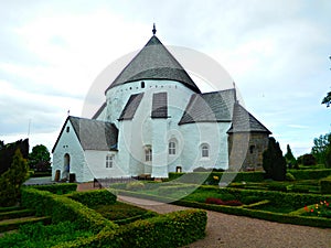 A stone rotunda church in ÃËsterlars, Bornholm, Denmark photo