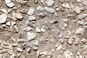 Stone rubble in the concrete wall as background