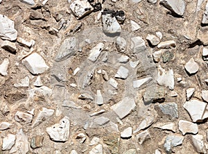 Stone rubble in the concrete wall as background