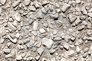 Stone rubble in the concrete wall as background