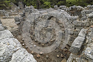 Stone ruins of houses and the street of the ancient city of Phaselis.