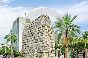 Stone ruins of old arab buildings with palms on the street of Al-Balad, Jeddah, Saudi Arabia photo