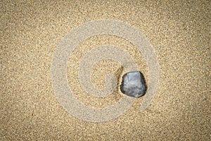 Stone on sand