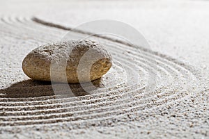 Stone on sand waves for concept of beauty spa with inner peace photo