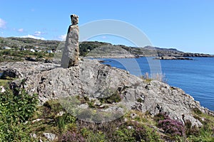 Stone sculpture in a coastal landscape in Norway, Europe.