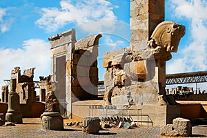 Stone sculpture of a horse in Persepolis against a blue sky with clouds. The Victory symbol of the ancient Achaemenid Kingdom.