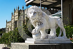 Stone sculpture of a lion in the open air on a Sunny day.