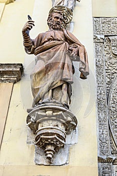 Stone sculpture representing San Pedro on the entrance facade to a church, Seville, Spain