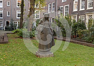 Stone sculpture of a tradional Beguine by Margaretha de Goede-Taal, Begijnhof, Amsterdam, The Netherlands