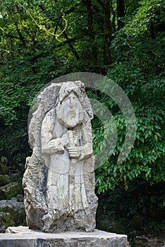 Stone sculpture among trees symbolises forest dwellers