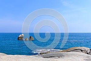 Stone and sea on blue sky background.