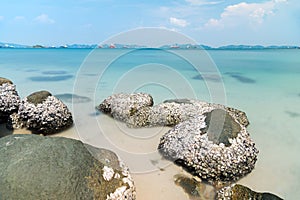 Stone in sea and wave on morning time with long exposure.